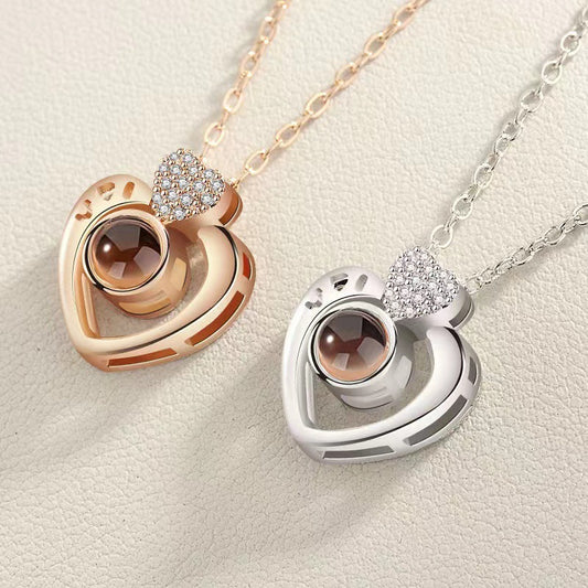 Two heart-shaped pendants on necklaces against a light background