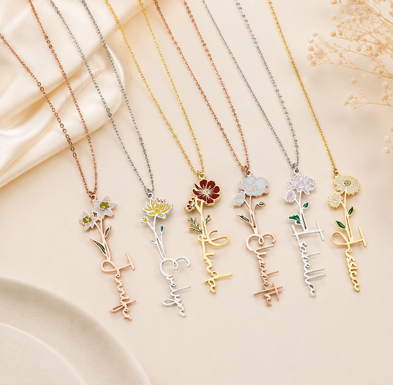 Set of floral and letter necklaces on a beige fabric background