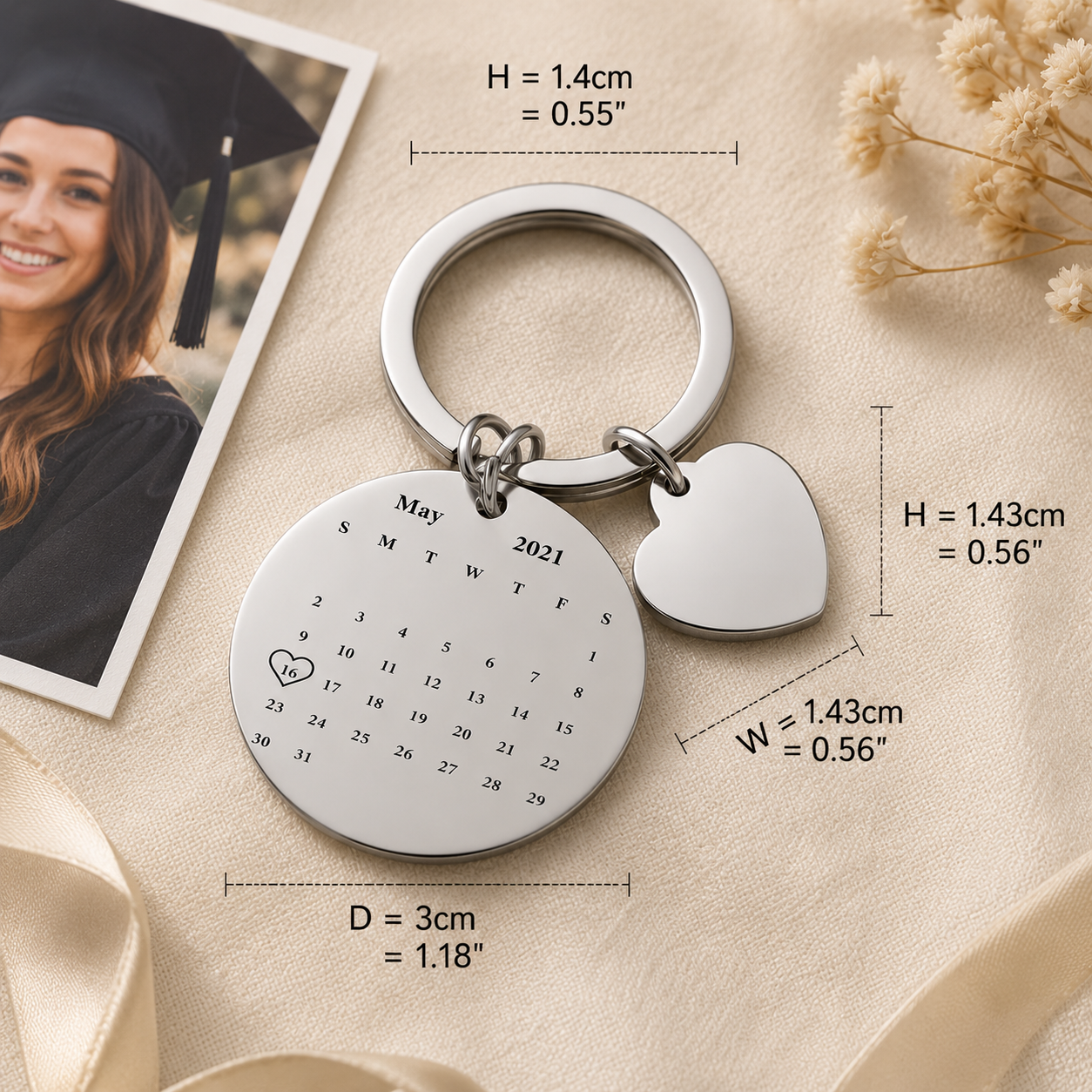 Keychain with calendar engraving and heart charm, shown with measurements and a graduation photo.