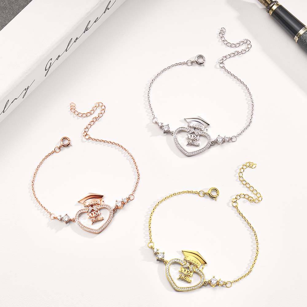Three heart-shaped bracelets in gold, rose gold, and silver on a white surface.