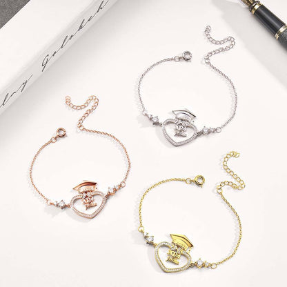 Three heart-shaped bracelets in gold, rose gold, and silver on a white surface.