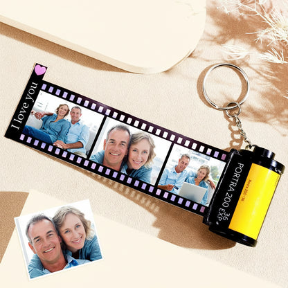 Keychain with film strip design featuring photos of a couple and text 'I Love You' on a pink background.