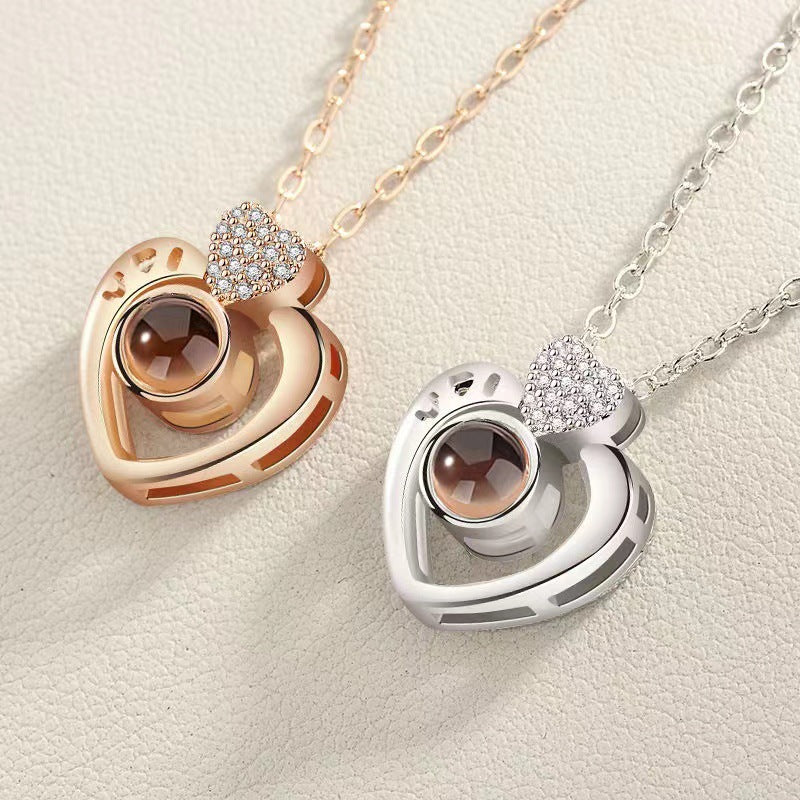Two heart-shaped pendants on necklaces against a light background