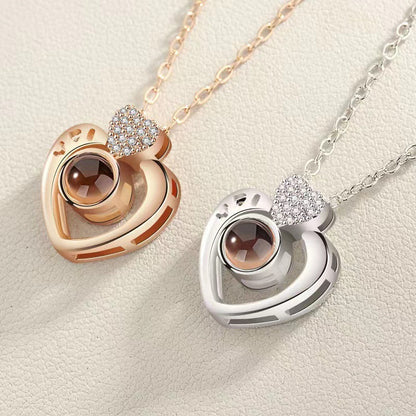 Two heart-shaped pendants on necklaces against a light background